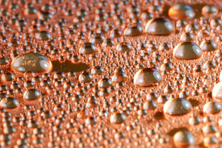 copper colored water drops close upの写真素材
