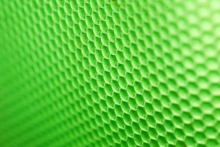 marco shot of a bee hive shaped background in greenの写真素材
