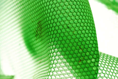 marco shot of a bee hive shaped background in greenの写真素材