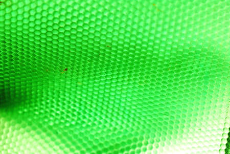 marco shot of a bee hive shaped background in greenの写真素材