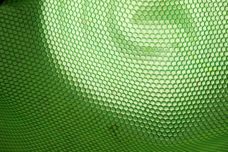 marco shot of a bee hive shaped background in greenの写真素材