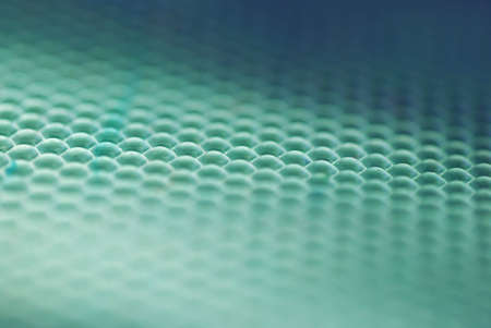 marco shot of a bee hive shaped background in greenの写真素材