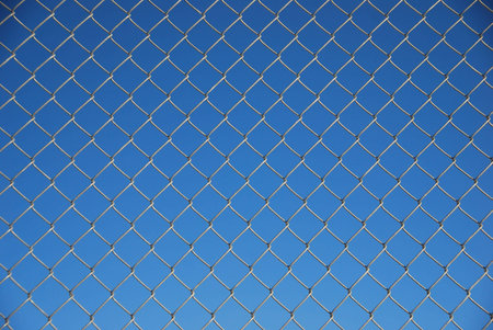 blue background with wire fence in front