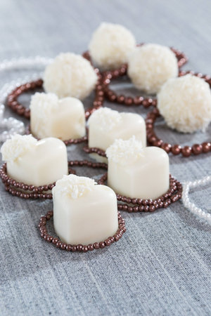 heart-shaped chocolates with candies in coconut flakes of beadsの写真素材