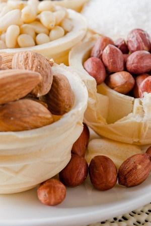 waffle basket with coffee beans, coconut, raisins, almonds, peanuts, hazelnuts and pine nutsの写真素材