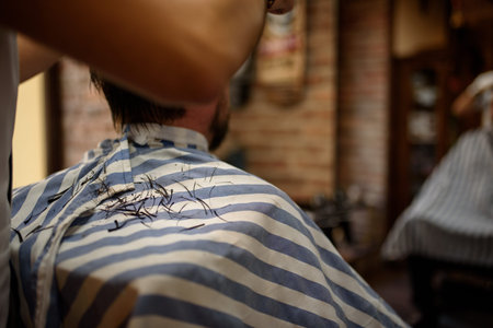 male hair cut while cutting on an apron