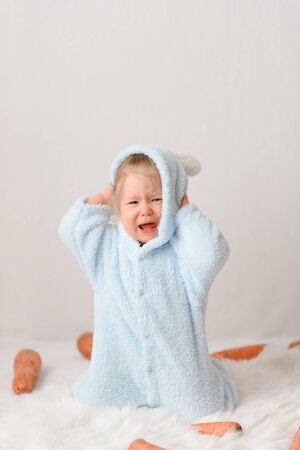 A little girl in a rabbit costume is surprised at the marking prices.の写真素材