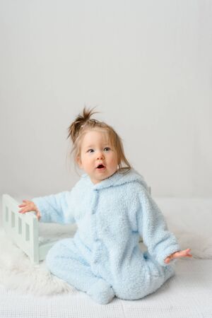 A little girl in a rabbit costume is surprised at the price of a carrot.の写真素材