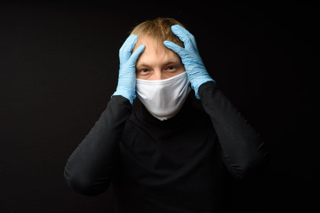 Protection against contagious disease, coronavirus. Man wearing hygienic mask to prevent infection...