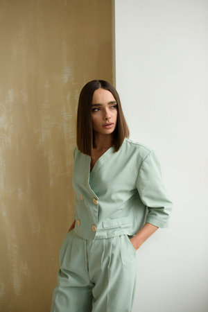 Close-up portrait of a young dark-haired woman. The girl is dressed in a jacket.