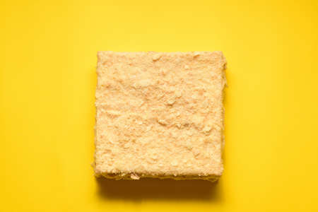Napoleon cake on a yellow background. Filmed from above. Place for a logo.の写真素材
