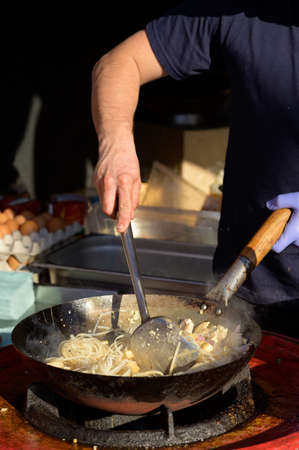 Fried vegetables with sausages and french friesの写真素材