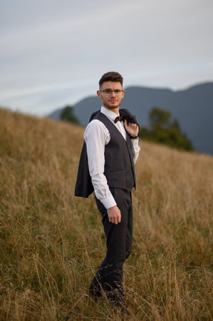 happy stylish bride and groom running and having fun in mountains on summer sunny dayの写真素材