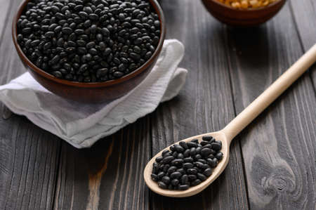 Fresh organic natural beans on wooden rustic black backgroundの写真素材