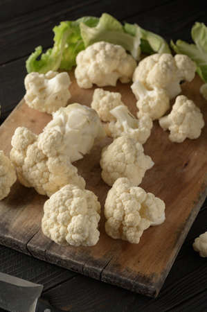 Raw, fresh organic cauliflower on a wooden background. Healthy eating, low carb diet conceptの写真素材