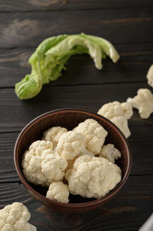 Raw, fresh organic cauliflower on a wooden background. Healthy eating, low carb diet conceptの写真素材