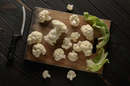 Raw, fresh organic cauliflower on a wooden background. Healthy eating, low carb diet conceptの写真素材