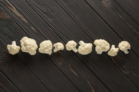 Raw, fresh organic cauliflower on a wooden background. Healthy eating, low carb diet conceptの写真素材
