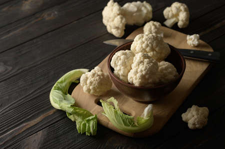 Raw, fresh organic cauliflower on a wooden background. Healthy eating, low carb diet conceptの写真素材