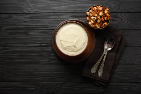 Cream of cauliflower soup on a dark wooden background.の写真素材