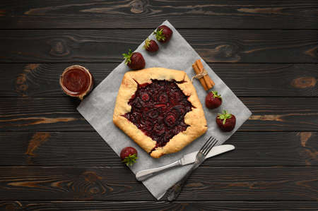 Strawberry galette on dark wooden background. home madeの写真素材