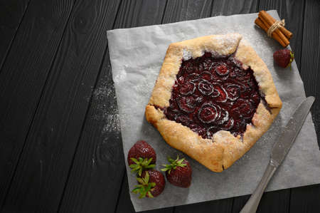 Strawberry galette on dark wooden background. home madeの写真素材