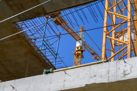 Crane and building construction site against blue sky