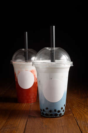 Milky bubble tea with tapioca pearls in plastic cupの写真素材