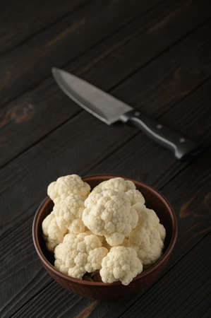 Raw, fresh organic cauliflower on a wooden background. Healthy eating, low carb diet conceptの写真素材