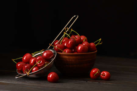 Sweet fresh cherry on a dark wooden background.の写真素材