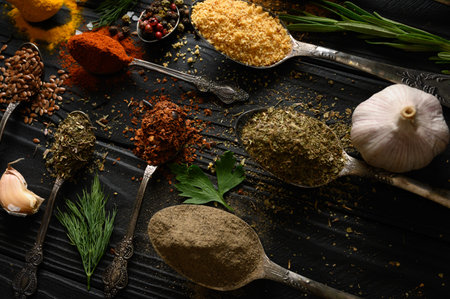 Colorful various herbs and spices for cooking on dark wooden rustic background