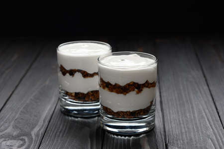Layered dessert with granola on a wooden dark wooden background.の写真素材