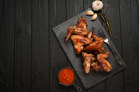 appetizing chicken wings grilled barbecue with spices and vegetables until crispの写真素材