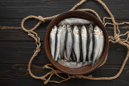 Fresh sardines on rustic wooden background.の写真素材