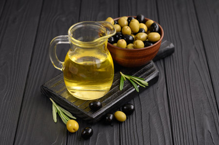 Black and green olives on a dark wooden black background.