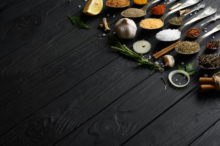Colorful various herbs and spices for cooking on dark wooden rustic backgroundの写真素材
