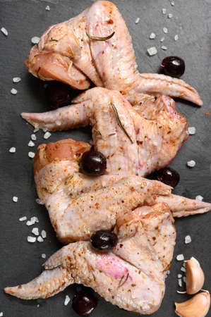 Marinated chicken wings with sweet cherry on a rustic wooden backgroundの写真素材