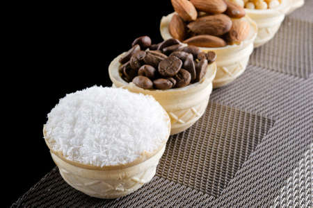 waffle basket with coffee beans, coconut, raisins, almonds, peanuts, hazelnuts and pine nutsの写真素材