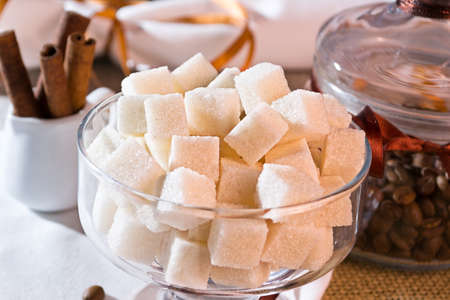 Glass with sugar and coffee beans decorated with ribbonの写真素材