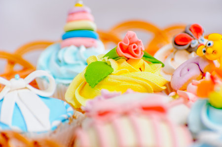many delicious colorful cupcakes in a basketの写真素材