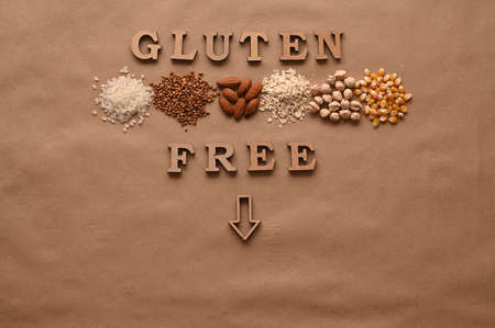 Gluten free text and gluten free products on brown background.の写真素材