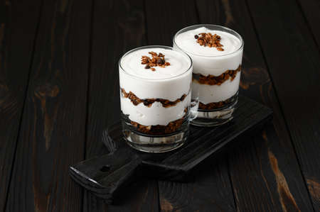Layered dessert with granola on a wooden dark wooden background.の写真素材