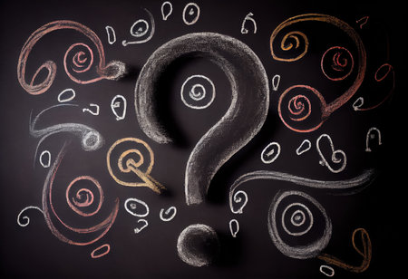 Question marks chalk drawing on blackboard background.の素材