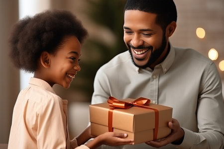 happy fathers day. African american kid son giving gift.の素材