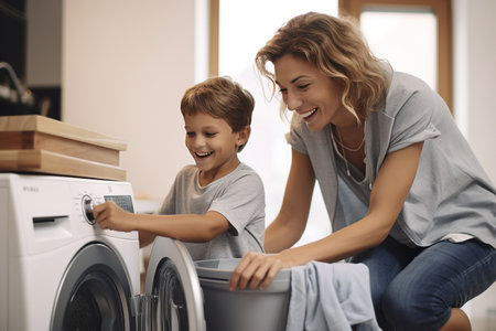 Son helping mom to load washing machineの素材