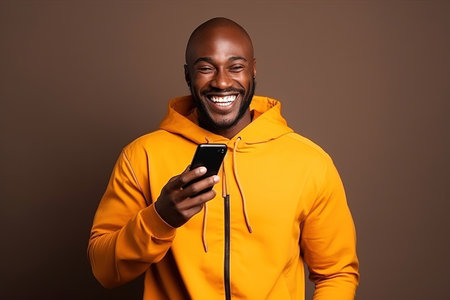 Black man with phone on studio background.の素材