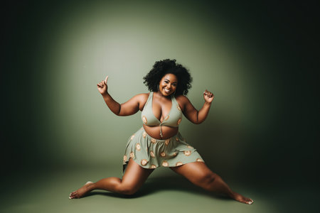 Confident body moves: Plus size woman having fun with her body in a color backgroundの素材