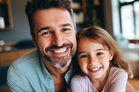 Father and daughter bonding at home on fathers dayの素材