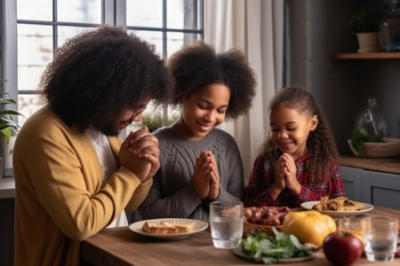 Happy multiracial family couple with children pray together before having morning breakfast at home together. Multiethnic parents with mixed race kids hold hands say prayer sit at kitchen tableの素材