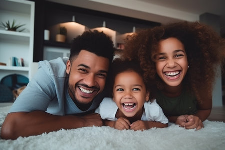 Loving parents having fun with their kids in the living room at homeの素材